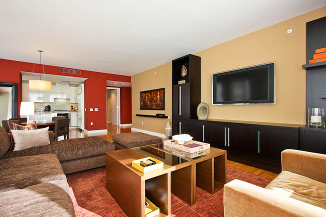 red accent wall, accent wall, interior design, san francisco interior design, high-rise, custom furniture, custom media unit, media unit, flat screen t.v., custom coffee table, unique coffee table